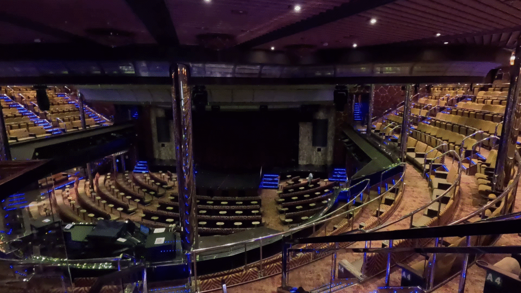 Encore Theater: The interior of the Encore Theater on the Carnival Dream, showing the multi-tiered seating, balconies, and stage from an upper deck view.