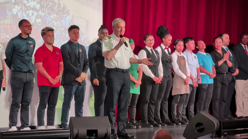 MSC Seascape Captain and crew members on stage during the disembarkation presentation at the Chora Theatre, recognizing staff and sharing departure day information with guests.