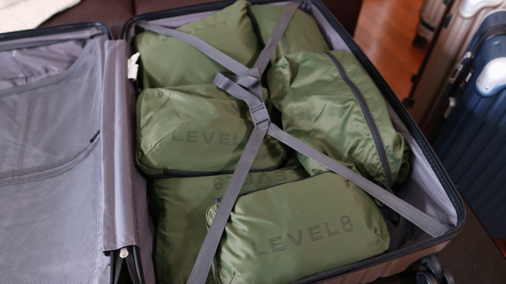 Level8 compression packing cubes organized inside a Level8 Grace checked suitcase, demonstrating how packing cubes help maximize luggage space and keep clothing organized while traveling.