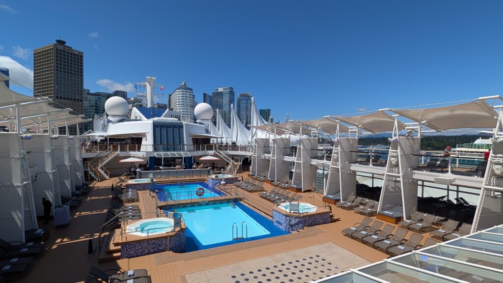 Lido Deck aboard Celebrity Solstice with pools, hot tubs, and lounge chairs on embarkation day.