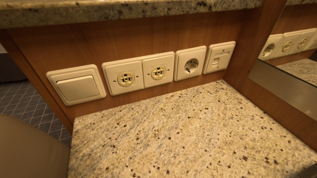 Celebrity Solstice vanity power outlets with two North American outlets and one European outlet.