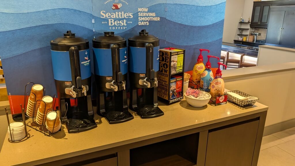 Complimentary coffee station and snack market in the lobby at the Country Inn & Suites by Radisson Seattle-Bothell.