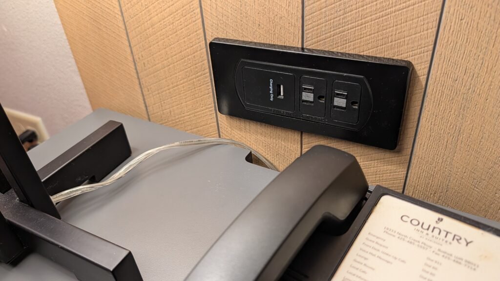 Power outlets and USB charging ports beside the bed in the King Suite.