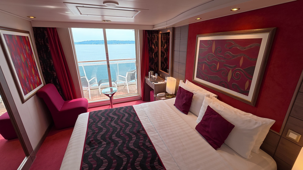 MSC Poesia aft balcony cabin 11250 on Deck 11 with bed, seating area, and balcony.