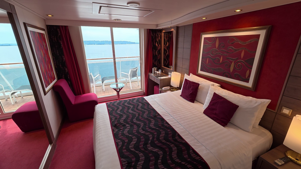 MSC Poesia aft balcony cabin 11250 on Deck 11 with king-size bed, seating area, and balcony.