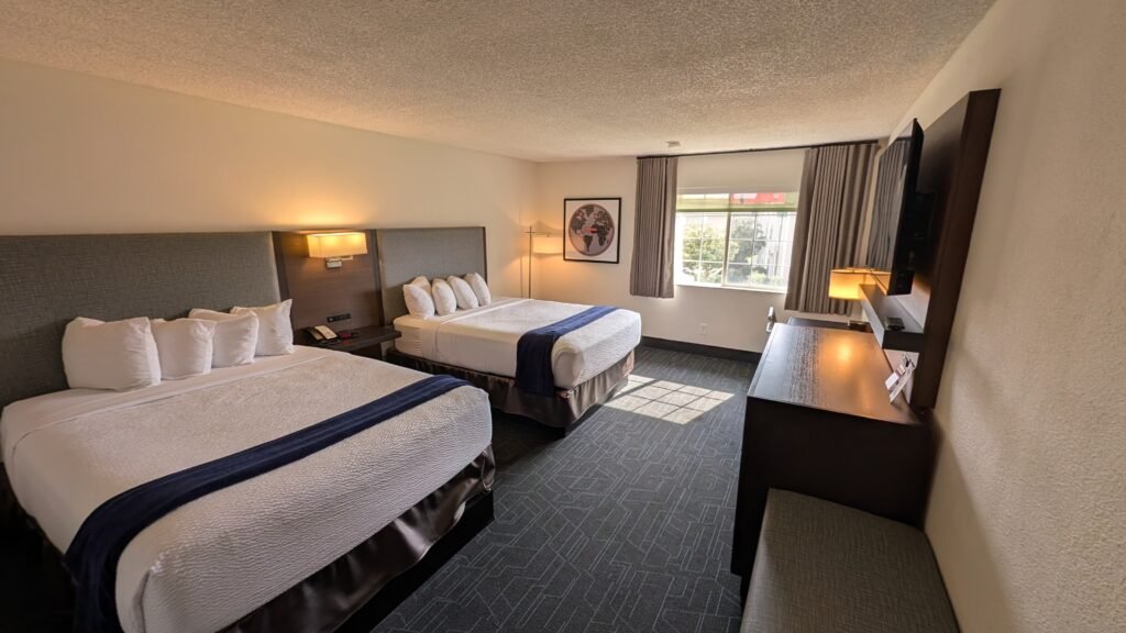 Standard guest room with two queen beds at Ramada by Wyndham Spokane Airport.