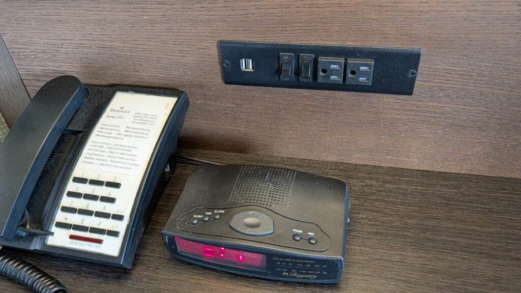 Electrical outlets and USB charging ports beside the bed at Ramada Spokane Airport.