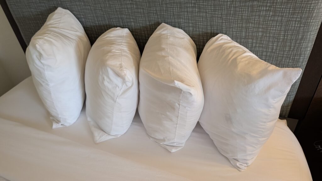 Four pillows on a queen bed at Ramada by Wyndham Spokane Airport.