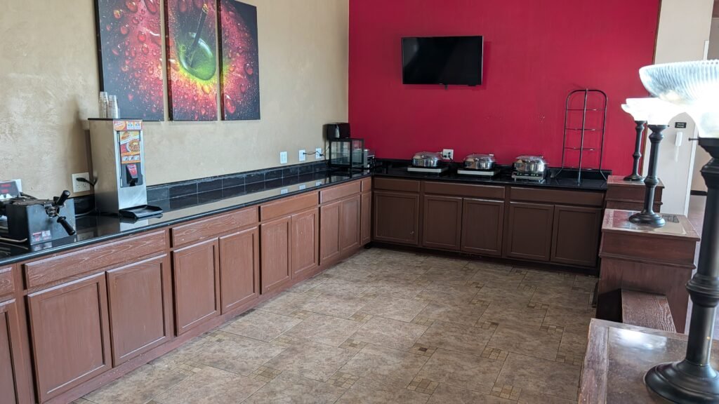 Complimentary breakfast serving area with food stations at Ramada by Wyndham Spokane Airport.
