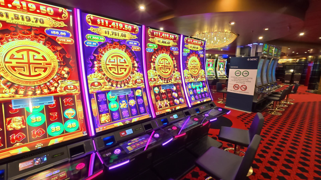 Rows of slot machines inside Casino Royal on the MSC Poesia cruise ship.