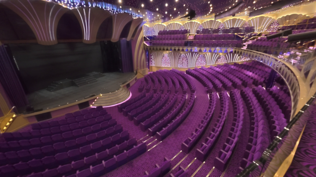 Teatro Carlo Felice theater aboard MSC Poesia with purple seating, balconies, and a large stage.